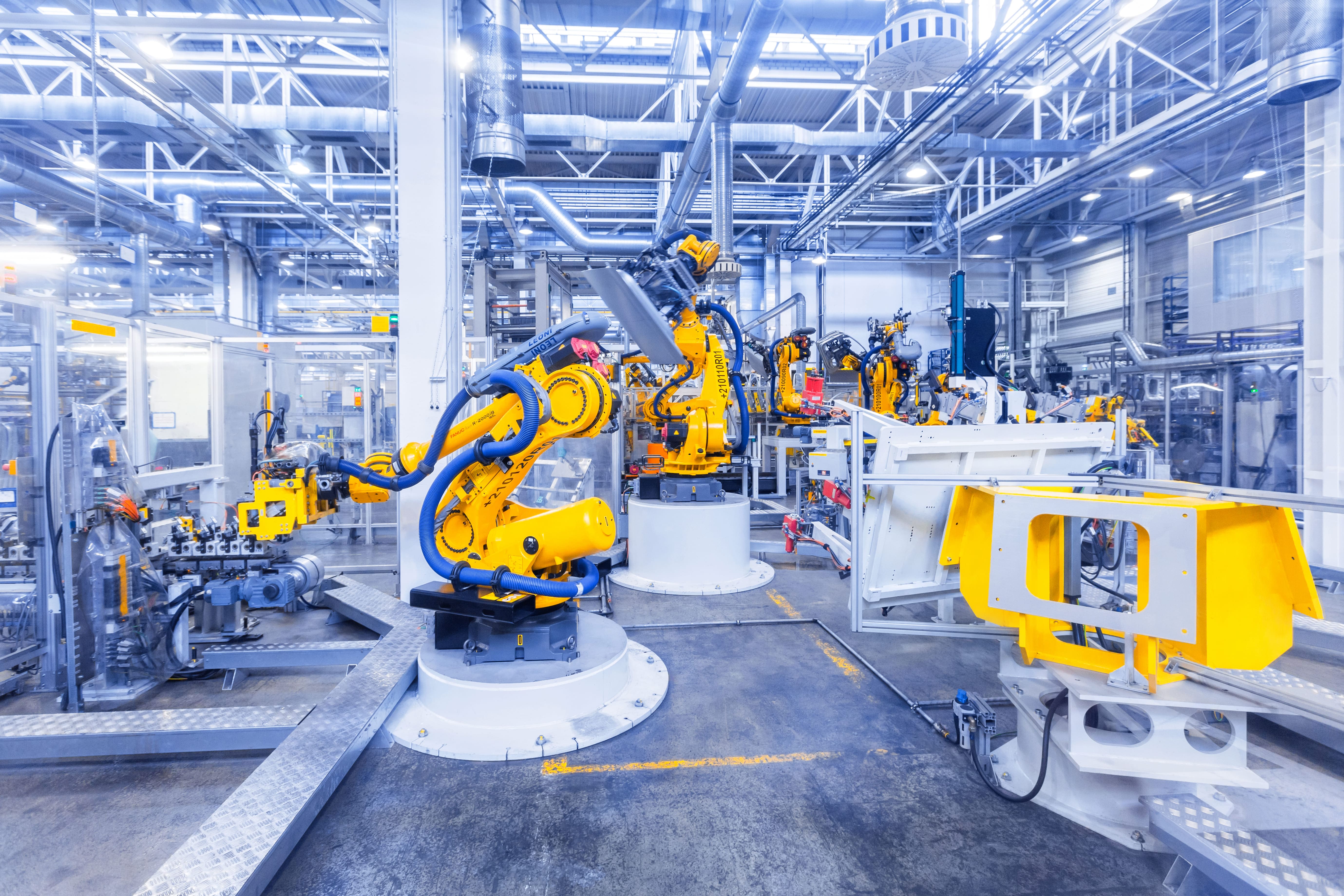 Industrial robotics and machinery inside a production facility.