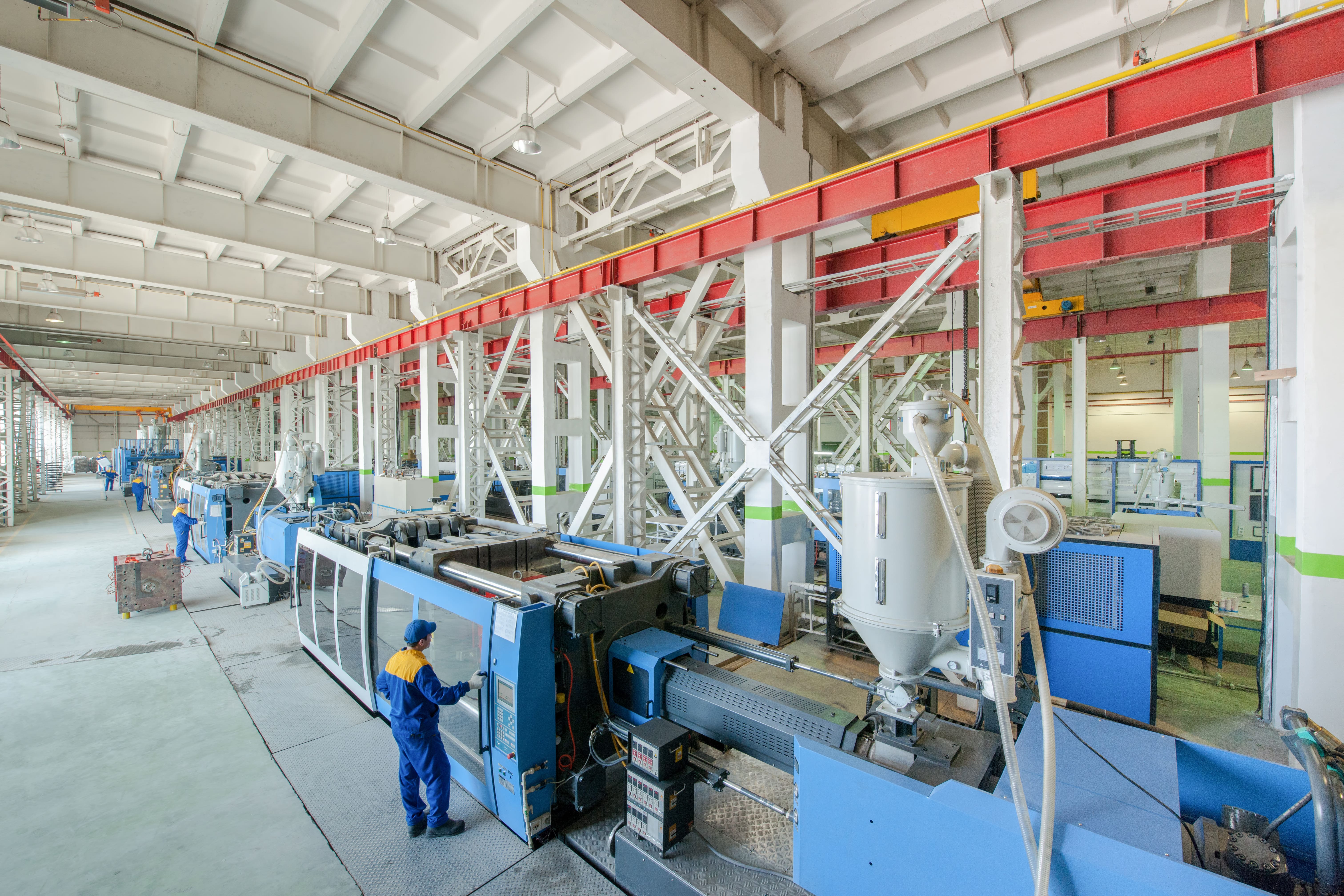 Industrial plastics production line inside a large facility.