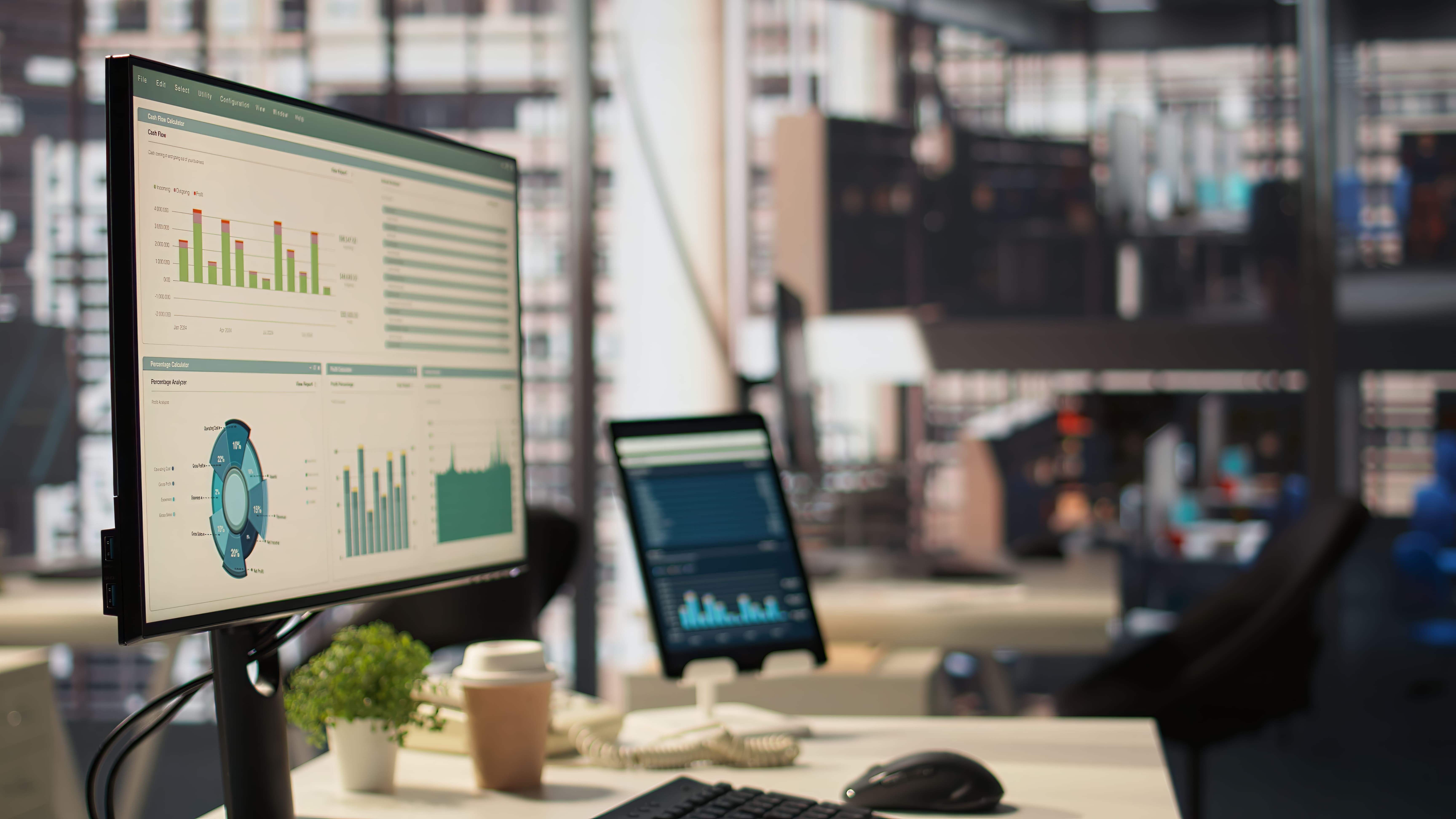 Operational performance and financial-value dashboards monitored beside a production operation.