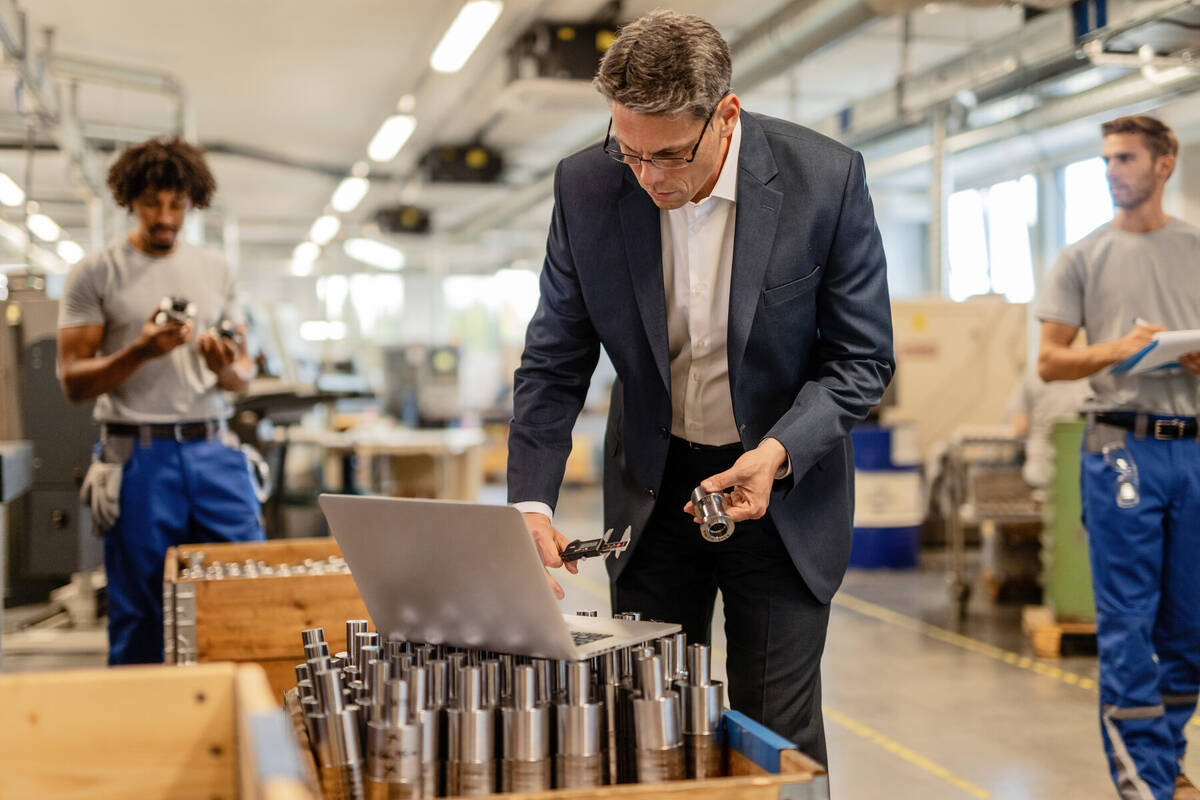 Operator reviewing an automated quality inspection at a production workstation.