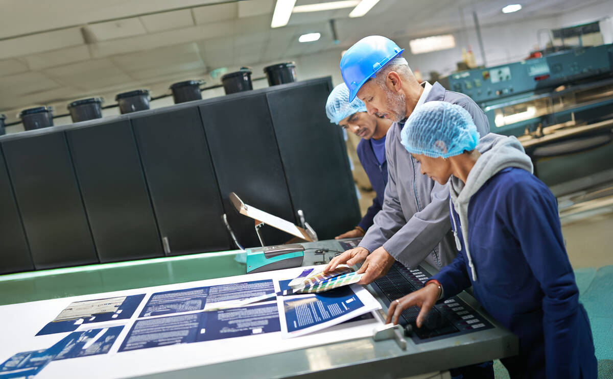 Quality specialists reviewing laboratory inspection results before release.